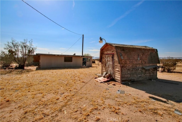 view of side of home featuring a storage unit