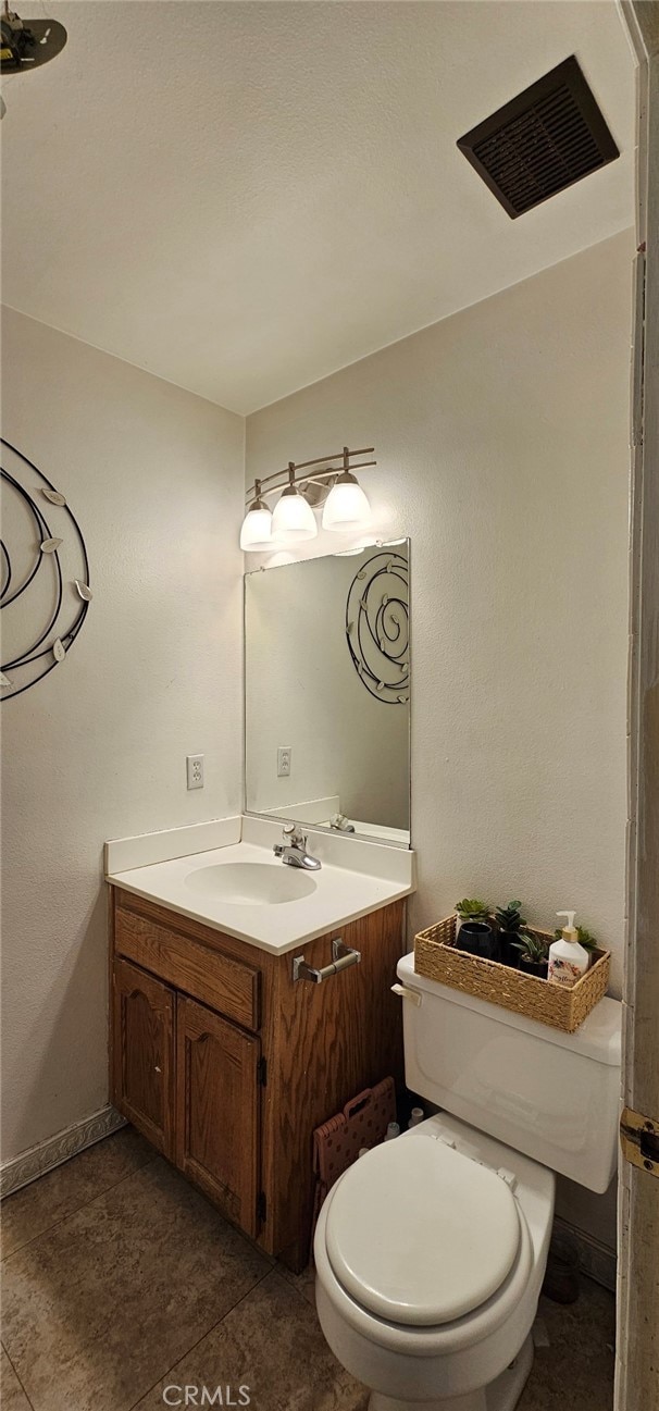 bathroom with toilet and vanity