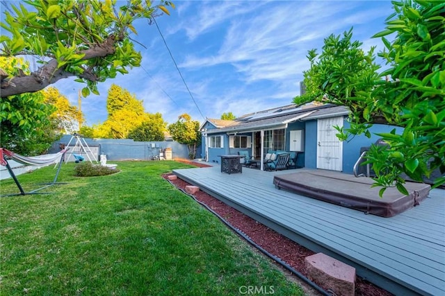 view of yard featuring a covered hot tub and a deck