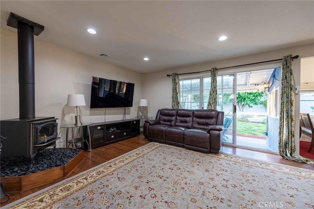 living room featuring a wood stove and hardwood / wood-style floors