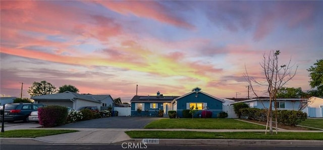 ranch-style home with a yard and solar panels