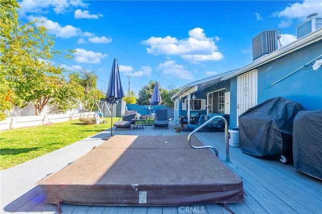 view of patio / terrace with a covered hot tub, a deck, and a grill