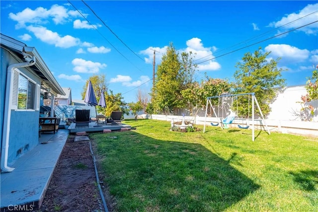 view of yard with a wooden deck and a playground