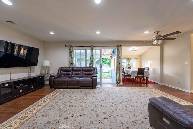 living room featuring ceiling fan and dark hardwood / wood-style flooring