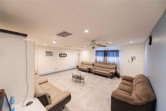 living room with a wall unit AC and ceiling fan