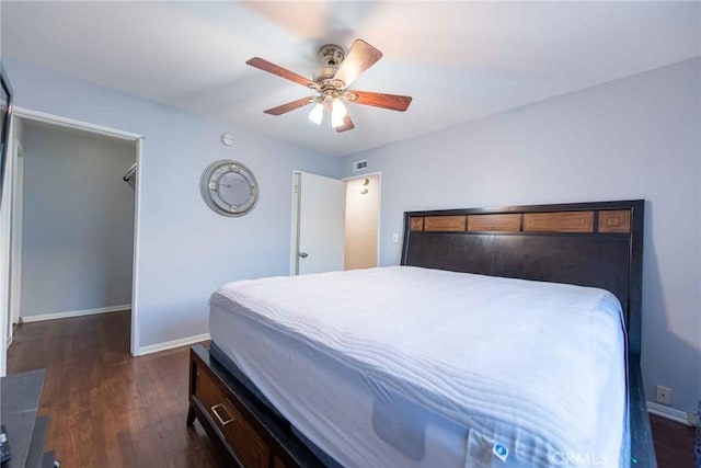 bedroom with ceiling fan and dark wood-type flooring