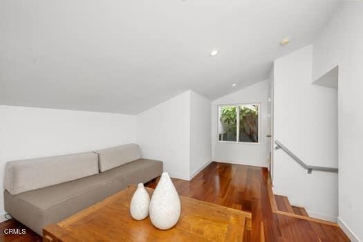 living room featuring hardwood / wood-style flooring and lofted ceiling