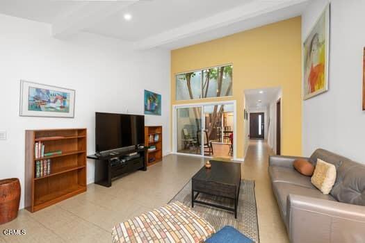 living room featuring beam ceiling