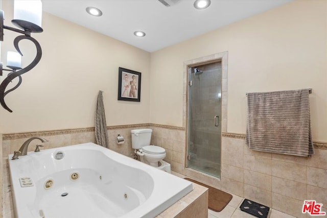 bathroom with tile patterned flooring, shower with separate bathtub, and toilet