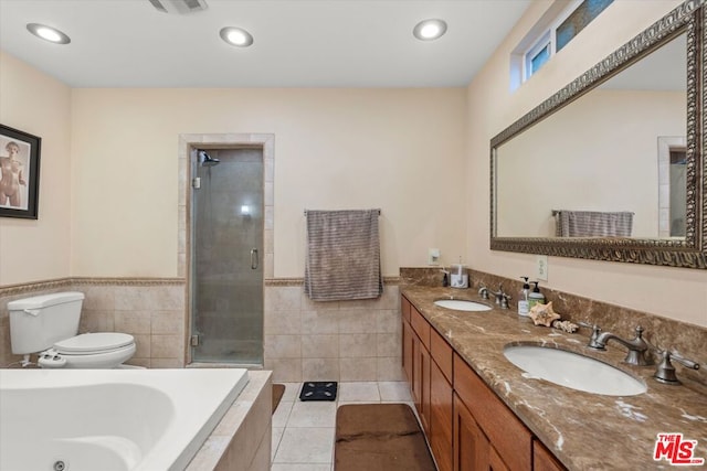 full bathroom with toilet, tile patterned flooring, vanity, and shower with separate bathtub