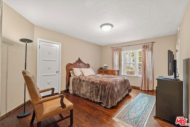 bedroom featuring dark wood-type flooring