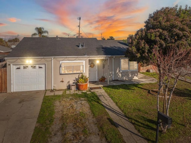 single story home featuring a yard and a garage