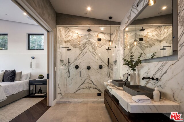 bathroom with walk in shower, lofted ceiling, and vanity