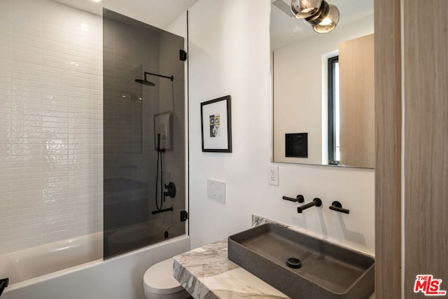 full bathroom featuring toilet, vanity, and  shower combination