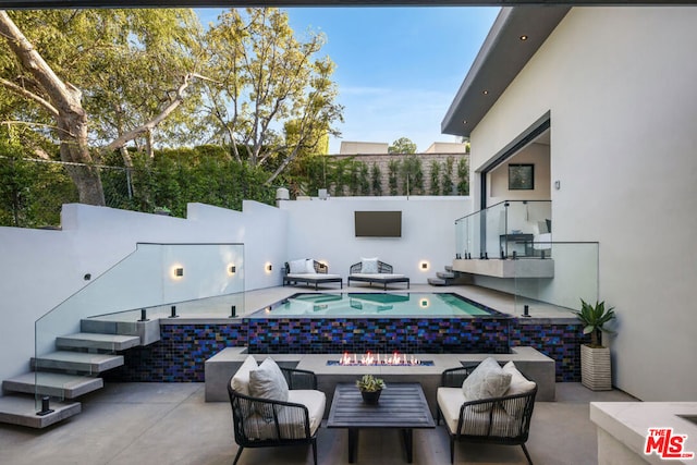 view of patio with a fenced in pool and outdoor lounge area