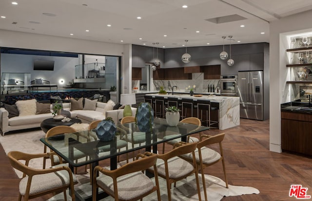 dining area with parquet floors and sink