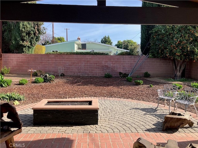 view of patio / terrace featuring an outdoor fire pit