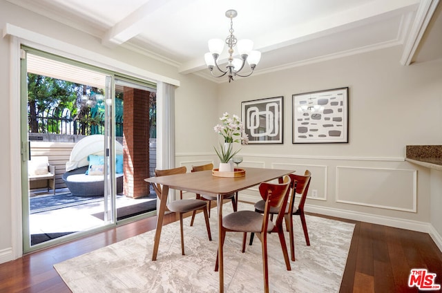 dining area with beam ceiling, hardwood / wood-style flooring, crown molding, and a notable chandelier