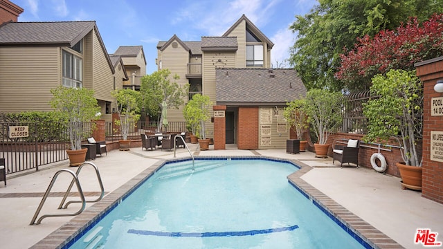 view of swimming pool with a patio