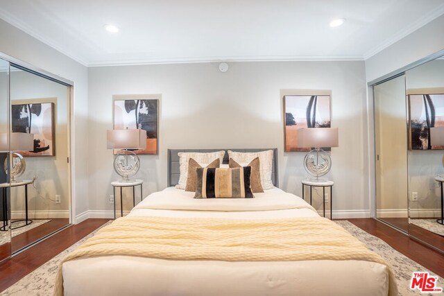 bedroom featuring a closet, dark wood-type flooring, and crown molding