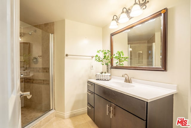 bathroom featuring vanity, tile patterned flooring, and walk in shower