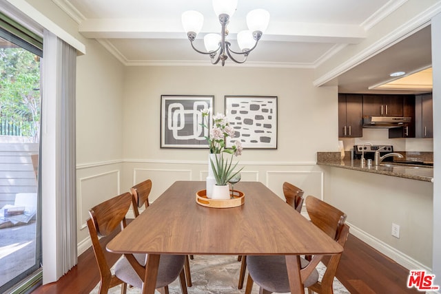 dining space with dark hardwood / wood-style floors, beamed ceiling, crown molding, and a chandelier