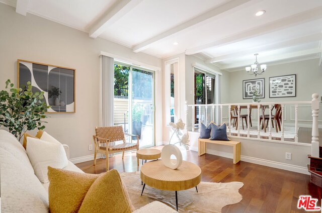 sitting room featuring wood-type flooring, beamed ceiling, and a chandelier