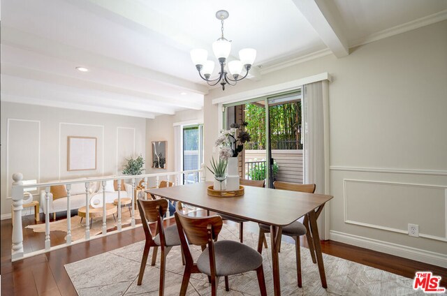 dining space featuring crown molding, beamed ceiling, an inviting chandelier, and hardwood / wood-style flooring