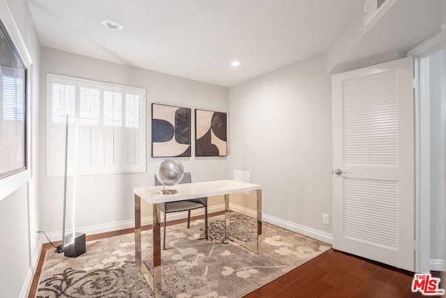 office with dark hardwood / wood-style flooring