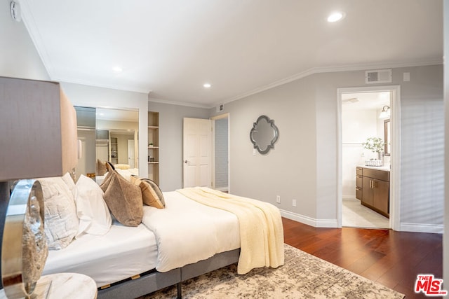 bedroom with light hardwood / wood-style floors, connected bathroom, and crown molding