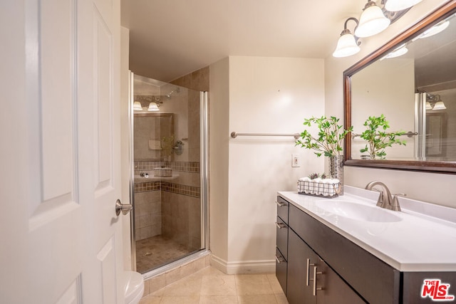 bathroom with vanity, tile patterned flooring, and a shower with door