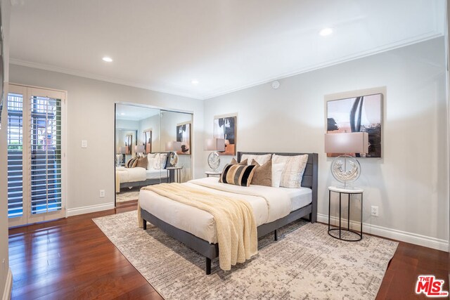 bedroom featuring dark hardwood / wood-style floors and ornamental molding