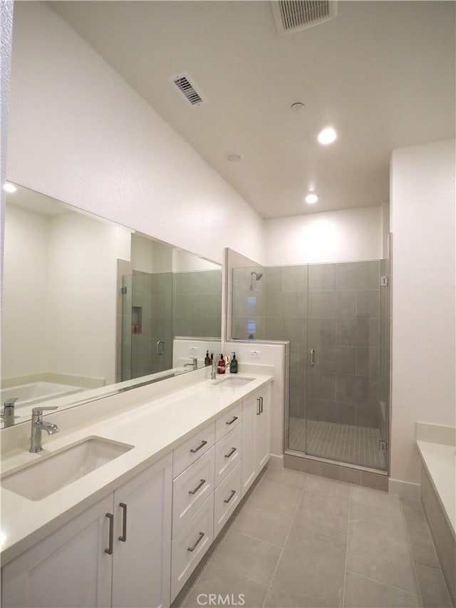 bathroom with vanity, tile patterned flooring, and a shower with door