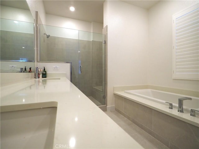 bathroom featuring separate shower and tub and vanity