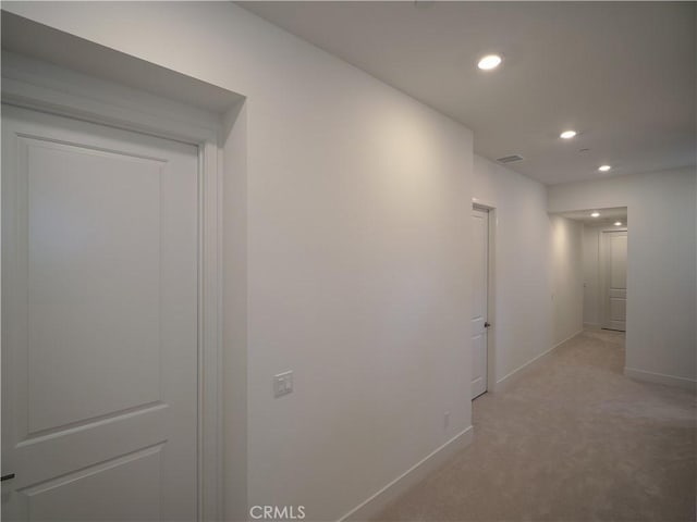 corridor with light colored carpet