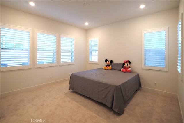 bedroom featuring light colored carpet