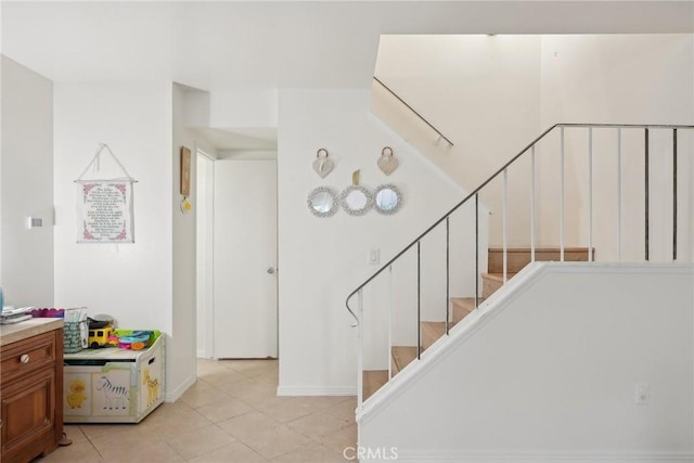 stairway with tile patterned flooring