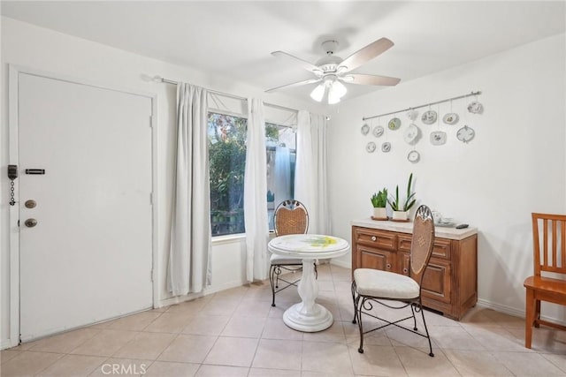 sitting room featuring ceiling fan and light tile patterned floors