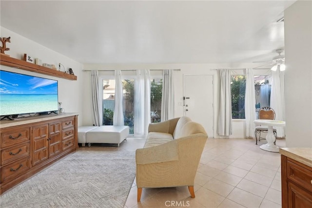 tiled living room featuring ceiling fan and plenty of natural light