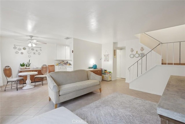 tiled living room with ceiling fan