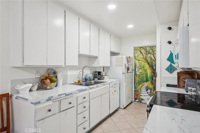 kitchen featuring light tile patterned floors, sink, white appliances, and white cabinets