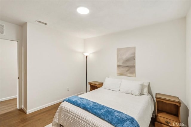 bedroom with hardwood / wood-style flooring