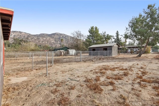 view of yard featuring an outbuilding and a mountain view