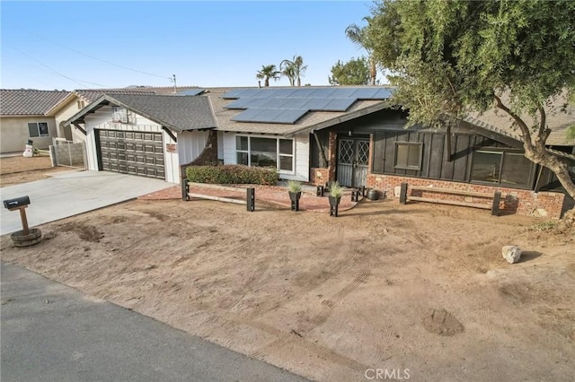 single story home featuring solar panels and a garage