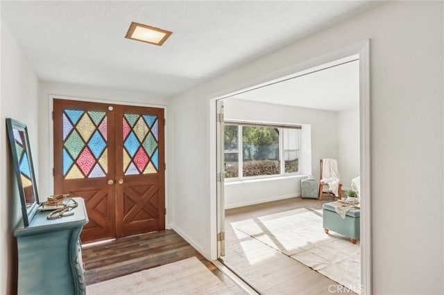 entrance foyer featuring dark hardwood / wood-style floors and french doors