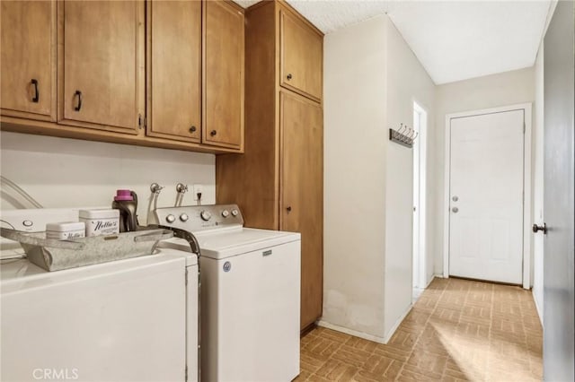 laundry room featuring cabinets and separate washer and dryer