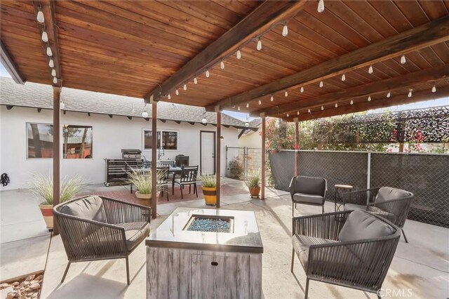 view of patio with a pergola and an outdoor living space with a fire pit