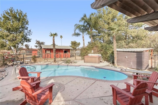 view of swimming pool with a storage unit and a patio