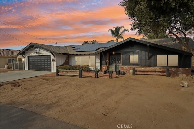 view of front of home with solar panels and a garage