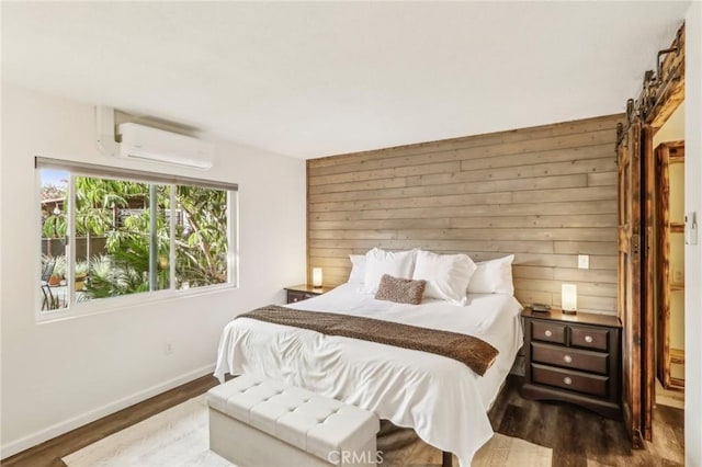 bedroom with dark hardwood / wood-style flooring, wooden walls, and a wall unit AC